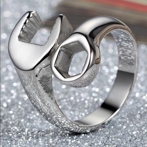 Stainless steel ring in shape of a twisted wrench